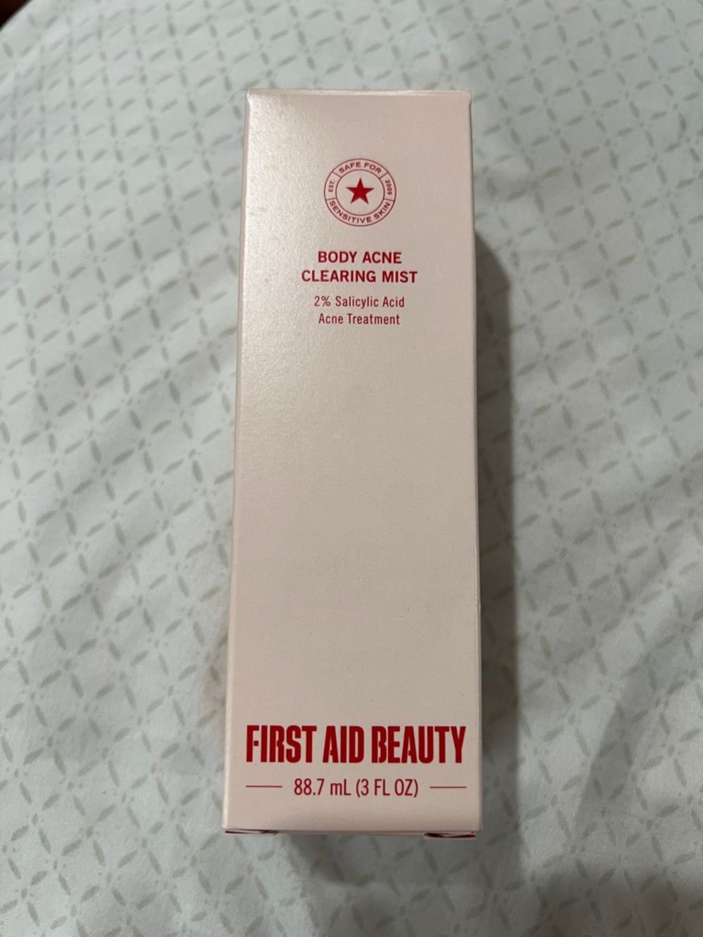 First Aid Beauty Body Acne Clearing Mist - White and Red Packaging
